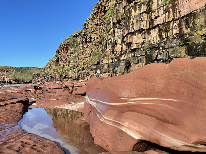 Fleswick Bay showing cliffs and foreshore made of a rock called the St Bees Sandstone.
