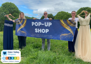 (left to right) Relationship Fundraiser, Martha Pardoe, Business Development Manager, Alex Groves and Fundraiser, Vicki Lesley with a selection of the dresses and suits.